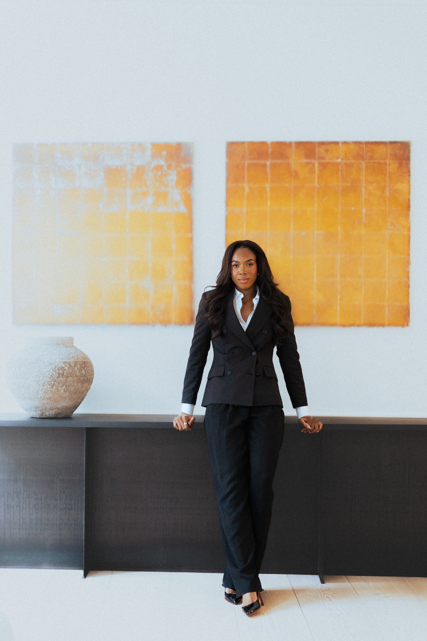 Woman wearing The Midnight suit indoors