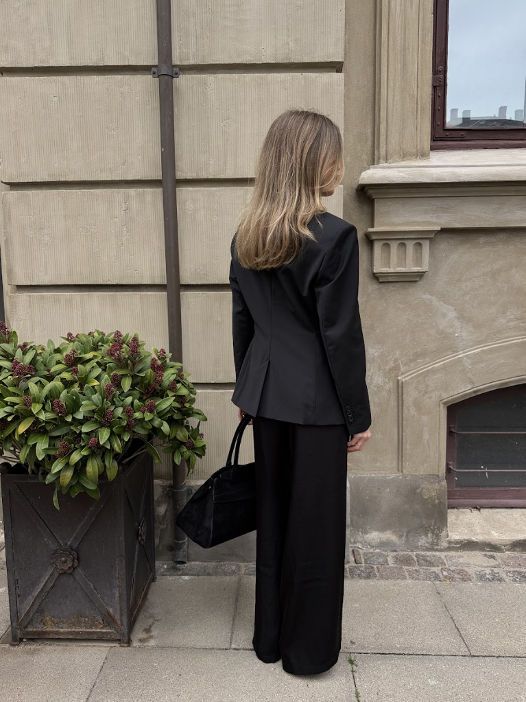 Woman wearing The Midnight blazer seen from behind